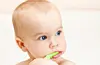 Little baby girl with green tooth brush