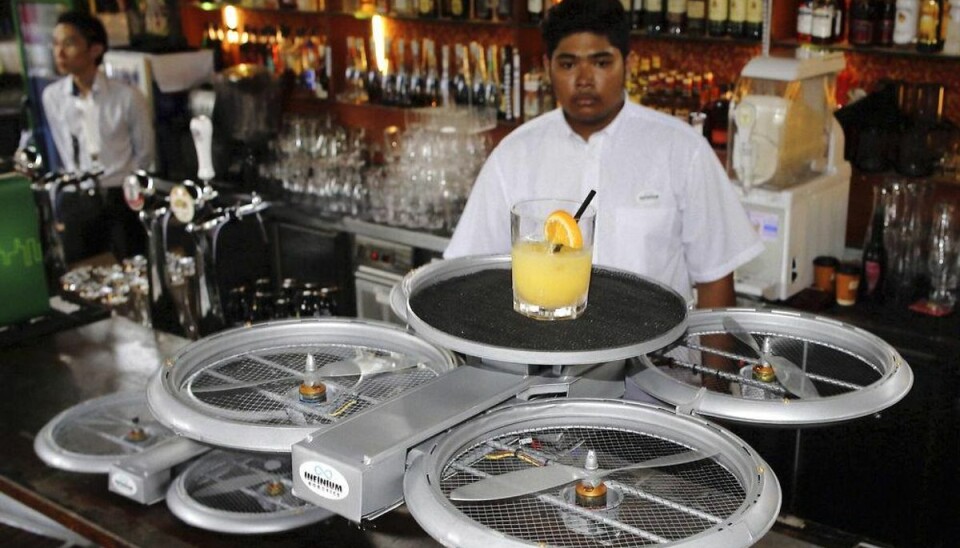 Mange frygter at blive erstattet af en robot Tjenere kan måske bliove erstattet af droner, der bringer bestillingen til gæsterne. Her testes en tjener-drone på en bar i Singapore. Foto: Edgar Su/Scanpix