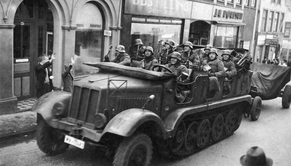 Historiker: Besættelsen vil også fascinere os om 100 år Tyske motorvogne kører gennem Aabenraas gader hilst af hjemmetyskere. Foto: Scanpix.