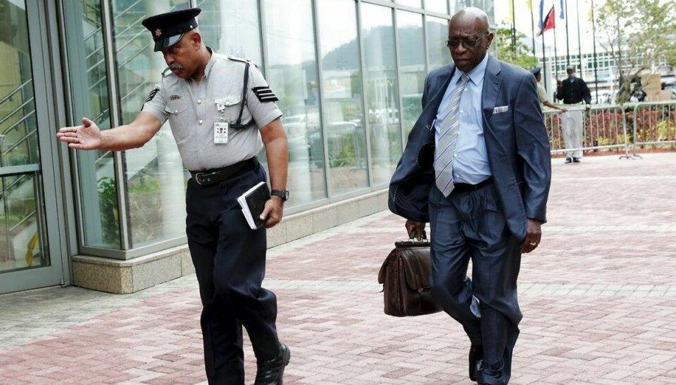 Former FIFA vice-president Jack Warner (R), who is a parliamentary representative for Chaguanas West, walks accompanied by a police officer as he arrives at the parliament building to attend a session in Port-of-Spain, May 29, 2015. Warner was among nine FIFA officials and five corporate executives charged by the U.S. Department of Justice with running a criminal enterprise that involved more than $150 million in bribes. REUTERS/Andrea De Silva TPX IMAGES OF THE DAY