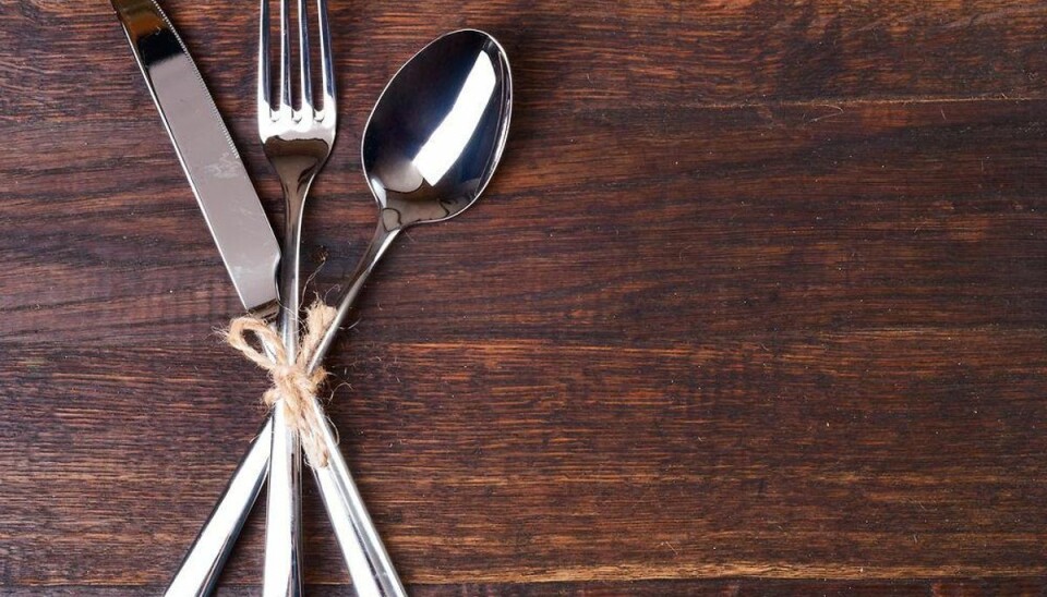 Table settings on wooden background.