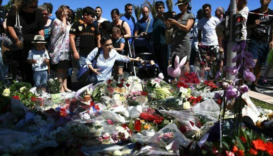 Folk lægger blomster ved promenaden i Nice, hvor en 31-årig fransk-tuneser torsdag aften pløjede en 19 ton tung lastbil ind i menneskemængden og dræbte mindst 84 mennesker. Foto: Anne-christine Poujoulat/AFP