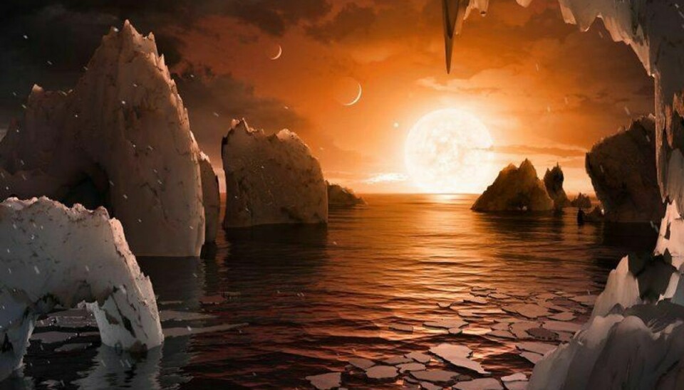 Her ses en kunstnerisk afbildning af, hvordan der kunne se ud på den ene af de syv jordlignende planeter, som Nasa har fundet i kredsløb om stjerne Trappist-1. Foto: Scanpix/Nasa