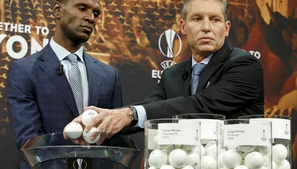 epa06382942 Michael Heselschwerdt (R), Head of Club Competition, next to former French soccer player Eric Abidal (L), ambassador for the UEFA Europa League final in Lyon, removes the balls containing the names of the soccer clubs during the drawing of the fixtures for the Europa League 2017/18 Round of 32 at the UEFA headquarters, in Nyon, Switzerland, 11 December 2017. EPA/SALVATORE DI NOLFI