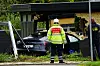 Beredskabsmedarbejder i refleksuniform ved en bolig med bil og stige.