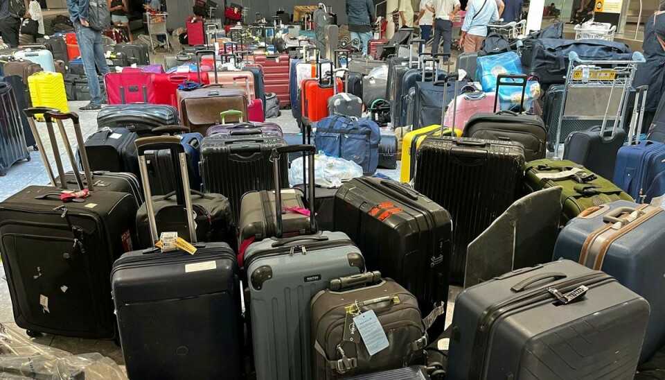 Uafhentede kufferter i Heathrow i London. Nu reagerer lufthavnen på personalemangel ved at sætte loft over antallet af passagerer, der kan komme afsted.