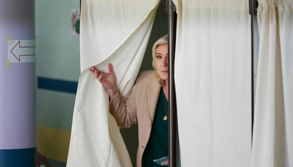 Lederen af partiet National Samling, Marine Le Pen, forlader stemmeboksen ved første valgrunde af det franske præsidentvalg søndag. En uofficiel måling fra Belgien viser dødt løb mellem hende og præsident Emmanuel Macron.