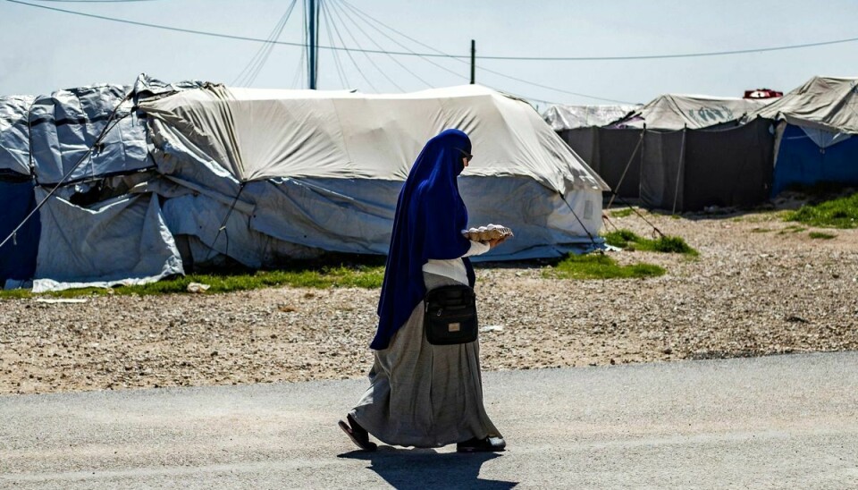 En kvinde ses gå igennem al-Roj-lejren i det nordøstlige Syrien. Tre danske mødre og 14 børn er natten til torsdag landet i Danmark efter at være blevet evakueret fra lejren. (Arkivfoto)