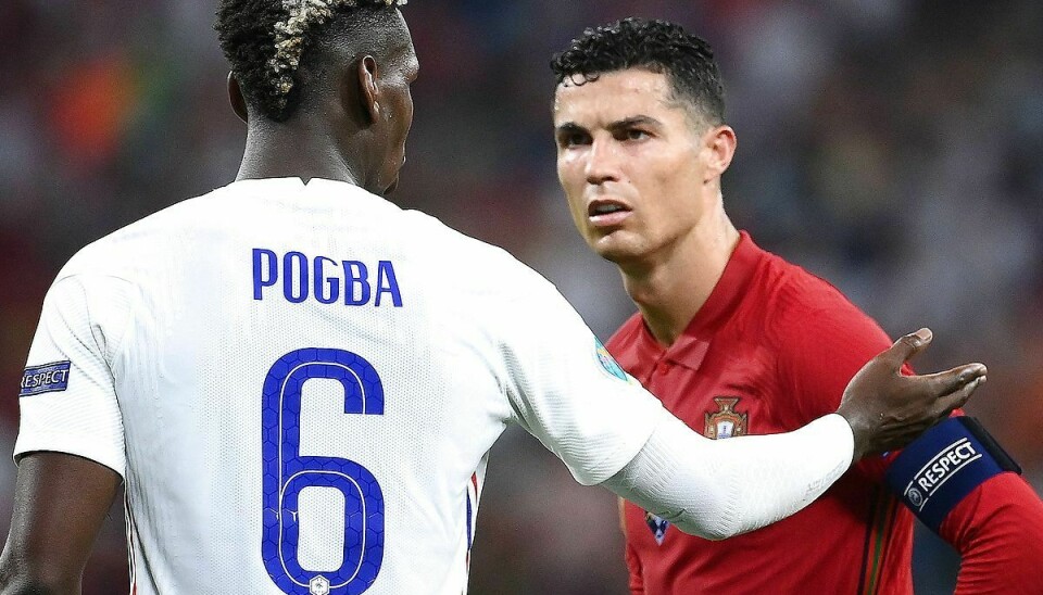 France's midfielder Paul Pogba interacts with Portugal's forward Cristiano Ronaldo during the UEFA EURO 2020 Group F football match between Portugal and France at Puskas Arena in Budapest on June 23, 2021. (Photo by FRANCK FIFE / POOL / AFP)